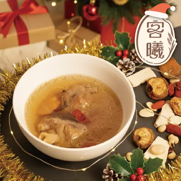 「白色湯碗盛裝熱騰騰的中式藥膳煲湯，內含雞肉、枸杞與多種藥材，周圍擺放聖誕節裝飾、禮物盒與松果，呈現節慶氛圍的溫暖湯品場景。」